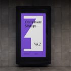 Front view, vertical city billboard mockup attached to the dark gray wall.
