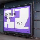 Horizontal city billboard mockup with a white, purple design attached to the wall.
