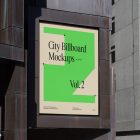 Big vertical city billboard mockup with bright beige, green design attached to the building elevation.