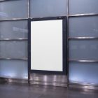 Vertical white city billboard mockup right at the subway station entrance attached to the wall.