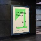 Vertical city billboard mockup with bright beige design attached to the black marble wall.