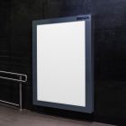 Vertical white city billboard mockup attached to the black marble wall.
