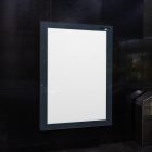 Vertical white city billboard mockup right at the subway station entrance attached to the black marble wall.