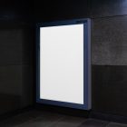 Vertical white city billboard mockup in the corner, attached to the black marble wall.