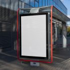 White city billboard mockup attached to the bus stop with the city view in the background.