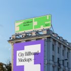Front view, two city billboard mockups attached to the building elevation, with the clean blue sky in the background.
