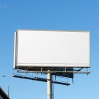 Front view, white city billboard mockup with the clean blue sky in the background.
