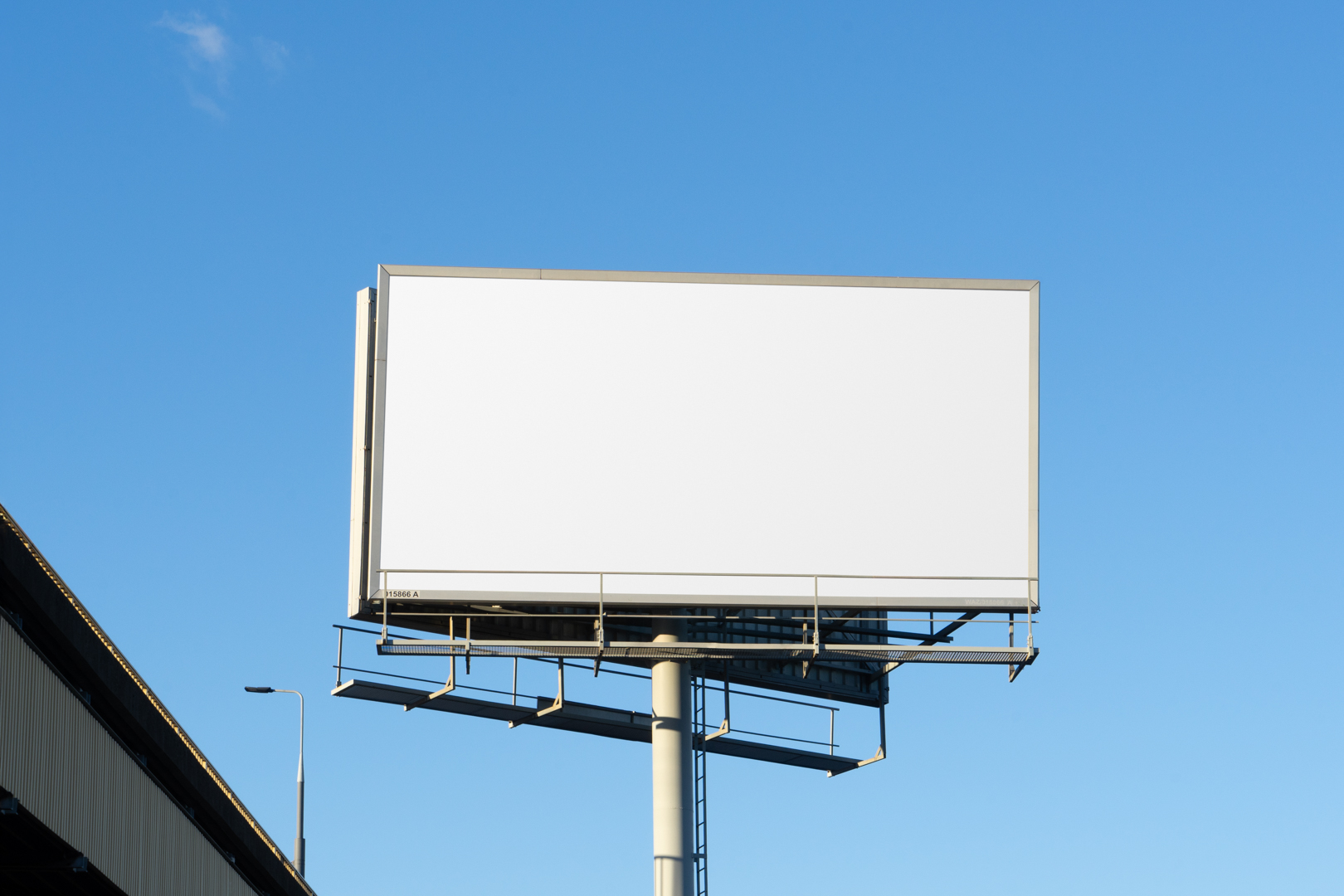 Front view, white city billboard mockup with the clean blue sky in the background.