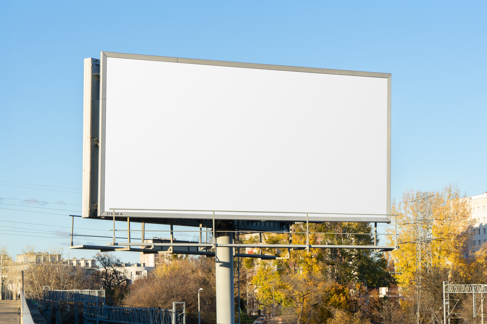 Front view, white city billboard mockup with silver frames and black, with the clean blue sky in the background.