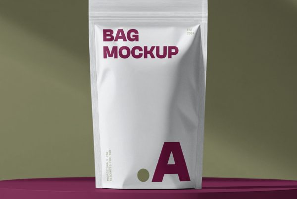 Front view, white plastic coffee bag mockup standing on the dark pink cubic in front of the dark green wall.