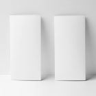Front view, two white Trifold Mockups standing on white floor, based on a white wall.