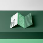 Front view, Trifold Mockup arranged in the letter z laying on a dark green box.