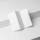 View from above, at a 45-degree angle of white Trifold Mockup based on two boxes with two shades of the white color.