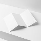 View from above, at a 45-degree angle of white Trifold Mockup arranged in the letter z and laying on a white box.