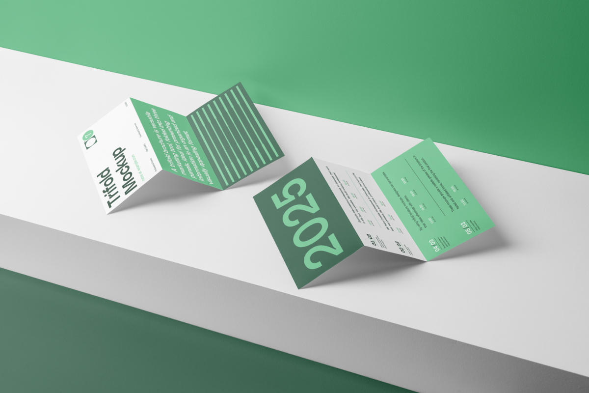 View from above, at a 45-degree angle of two Trifold Mockups arranged in the letter z and laying on a white box.