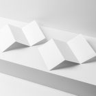 View from above, at a 45-degree angle of two white Trifold Mockups arranged in the letter z and laying on a white box.