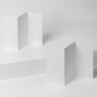View from above, at a 45-degree angle of two white Trifold Mockups arranged in the letter z. Both of them are standing on the white boxes.
