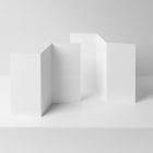 View from above, at a 45-degree angle of two white Trifold Mockups arranged in the letter z. Both of them are standing on the white box.