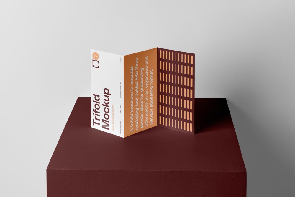 Front view, from above, with a little angle of single standing on a dark claret box Trifold Mockup arranged in the letter z. Behind the claret box is a huge white wall.