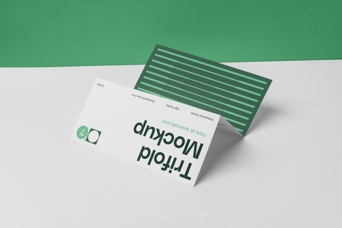 Front view, of Trifold Mockup arranged in the letter z and laying on a white box. Behind the white box is a huge green wall.