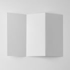 View from above, of a single white Trifold Mockup arranged in the letter z laying on white floor.