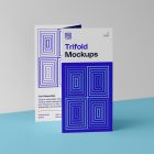 Front view, of a single Trifold Mockup arranged in the letter z standing on a blue floor. Behind the Trifold Mockup is a huge white wall.