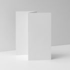 Front view, of a single white Trifold Mockup arranged in the letter z standing on a white floor. Behind the Trifold Mockup is a huge white wall.