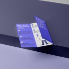 View from above, at a 45-degree angle of an open Trifold Mockup laying on a purple box.