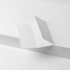 View from above, at a 45-degree angle of an open white Trifold Mockup laying on a white box.