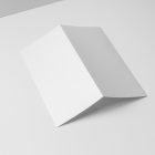 View from above, at a 45-degree angle of a white Trifold Mockup laying on a white box.