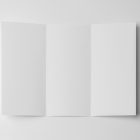 View from above, of a single open white Trifold Mockup laying on the white floor.