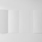 View from above, of a two white Trifold Mockups laying on white floor.