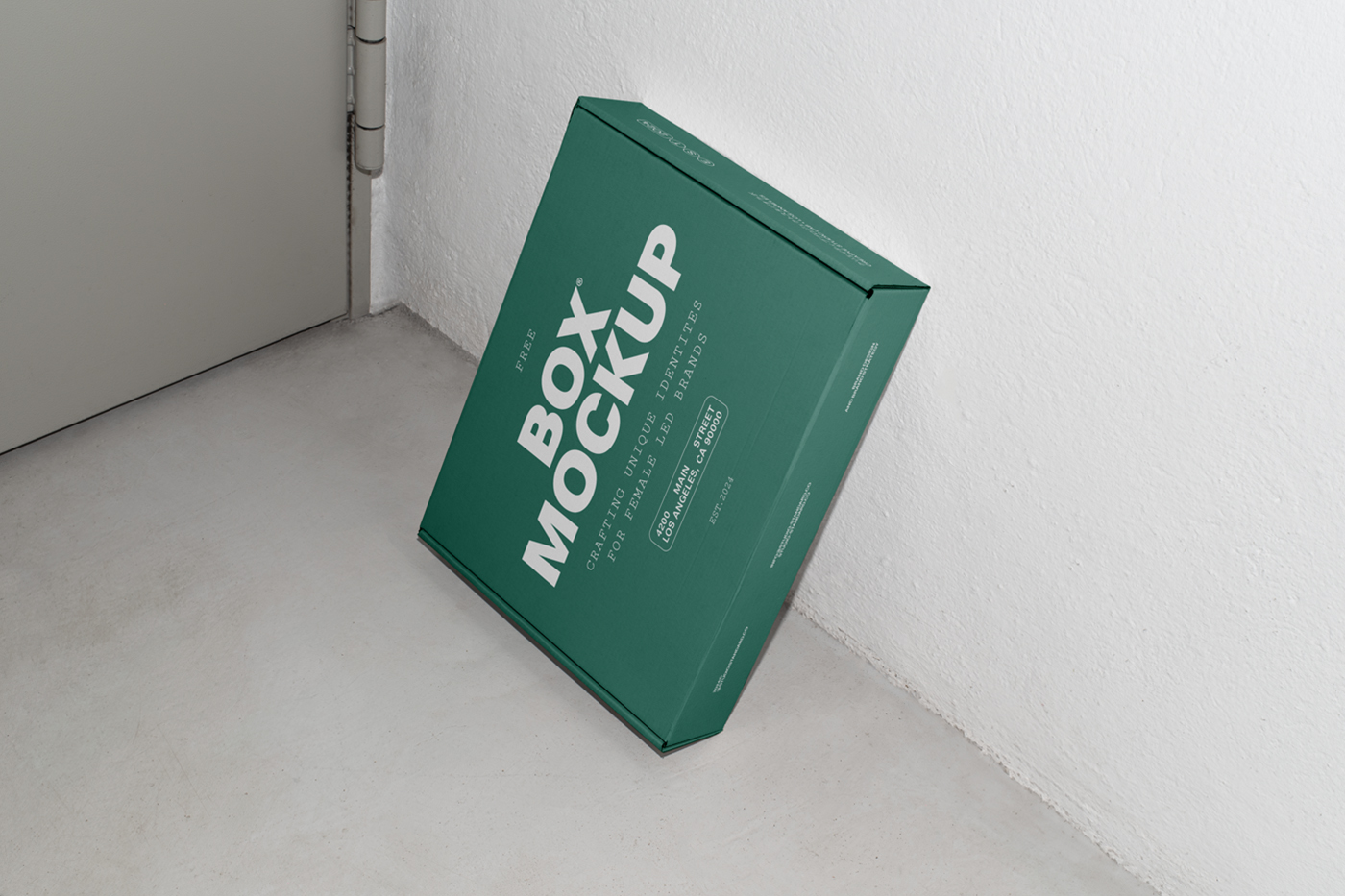 View from above of a green box mockup with white strong typography design based on white wall.