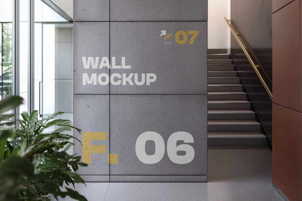 Front view, concrete wall mockup with strong white and yellow typography design inside the building and visible stairs behind.