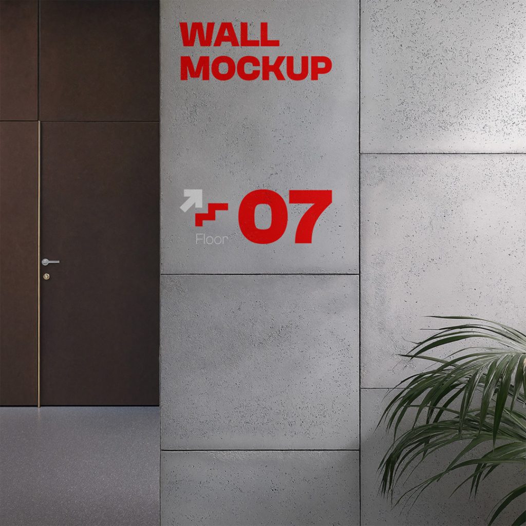 Front view, concrete wall mockup with strong red typography design inside the office and a visible wooden door and stairs behind.