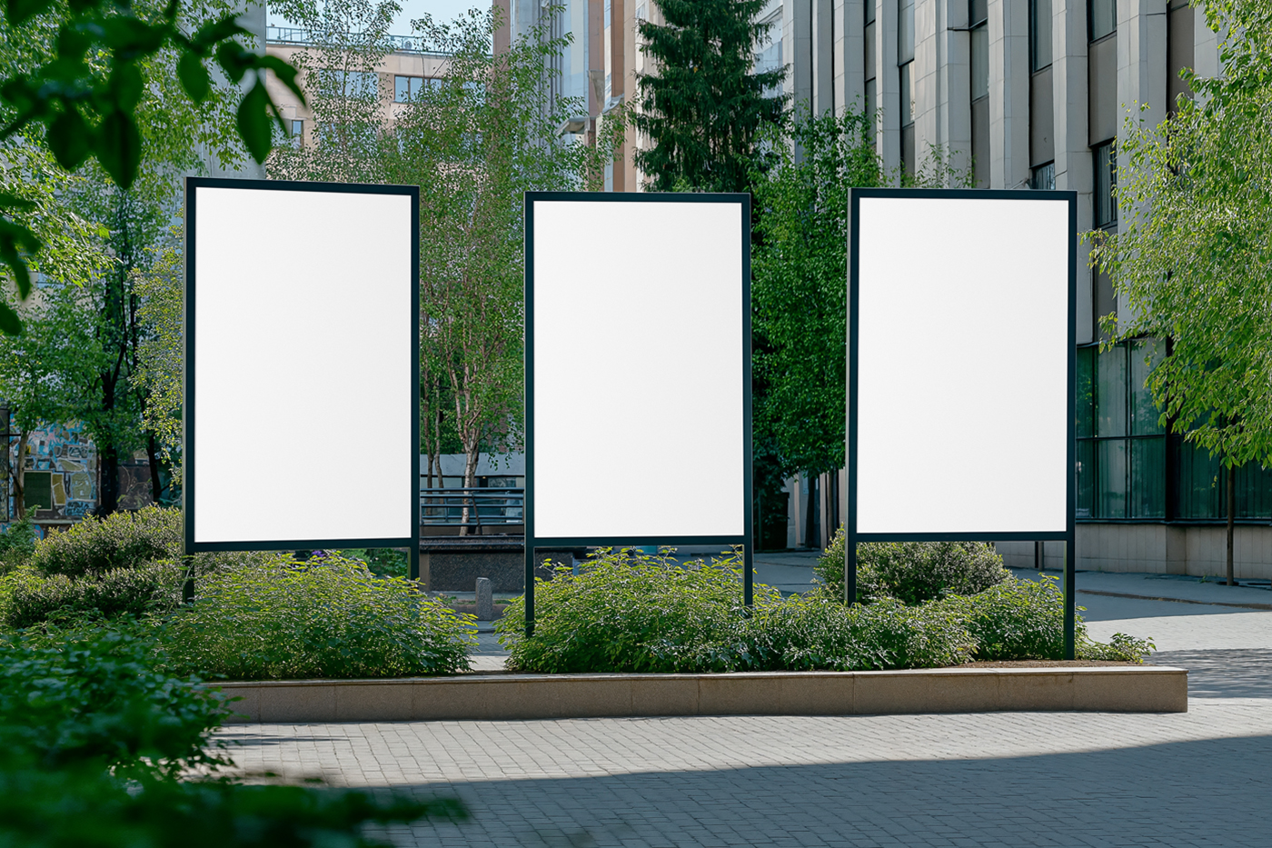 Front view, three vertical blank poster mockups standing between buildings.