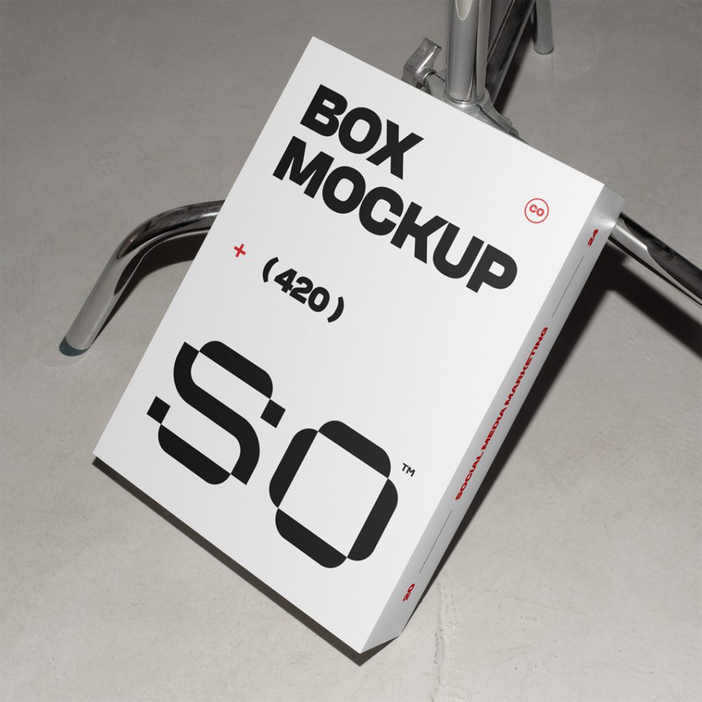 View from above of a white box mockup with black strong typography design based on metal tripod.
