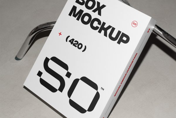 View from above of a white box mockup with black strong typography design based on metal tripod.