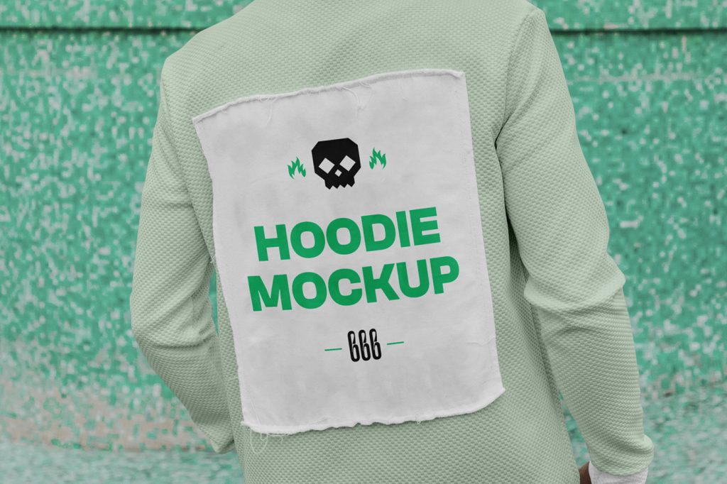 Front view, standing men standing with his torso to the lens wearing a hoodie mockup with typography design between dirty space area.