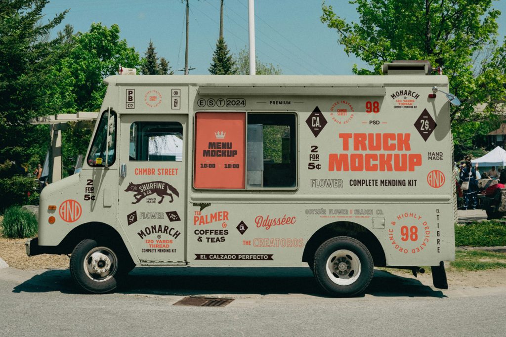 Front view, vintage food truck mockup with a lot of colorful graphics design on the bodywork standing in the parking lot near the festival