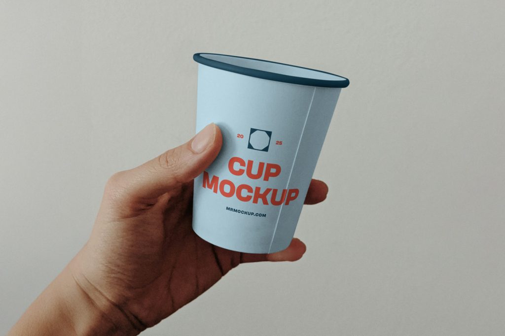 Front view, a man holding a coffee cup mockup with typography design with a bright green color wall in the background.