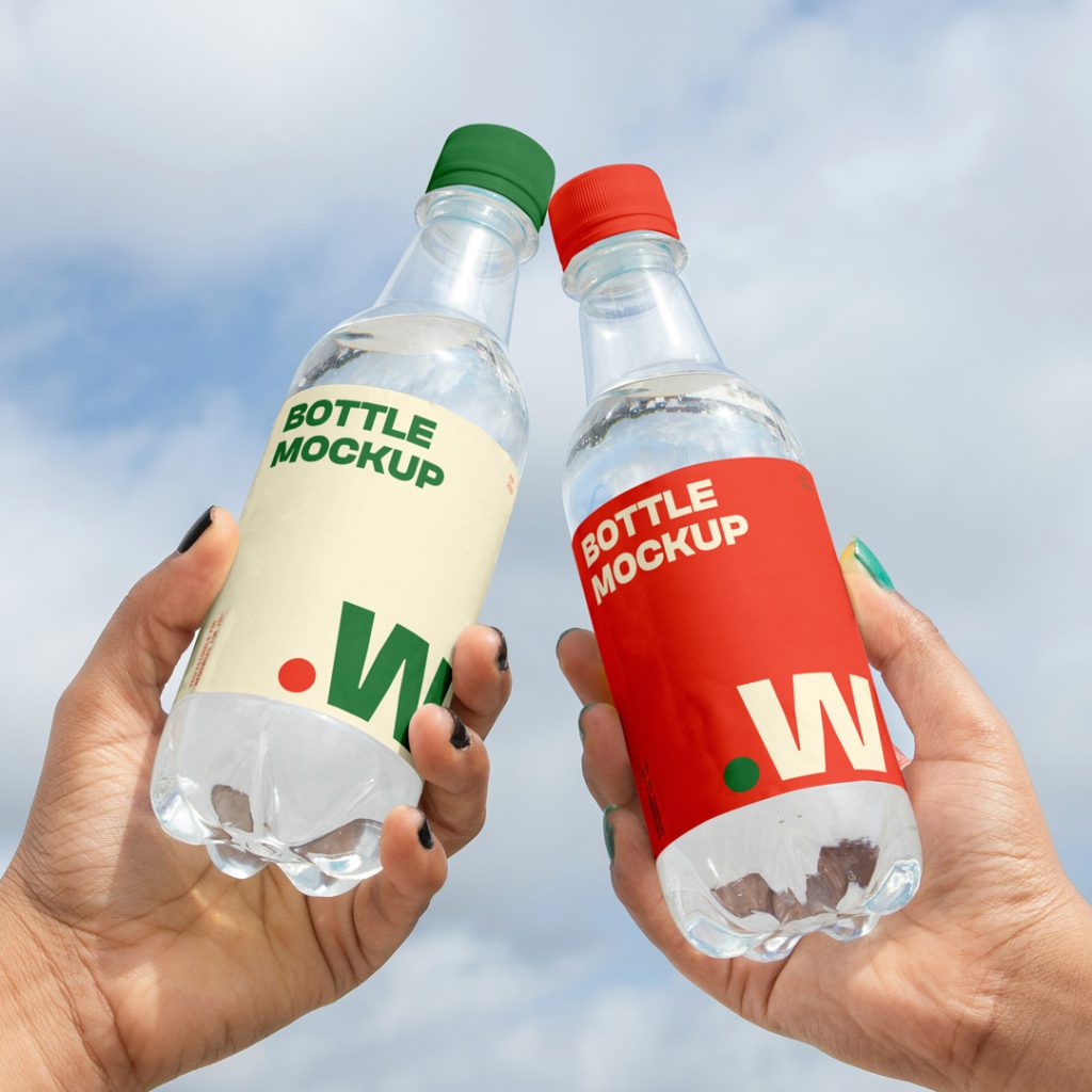 Two people holding a bottle mockup in hand with a view of the sky in the background.