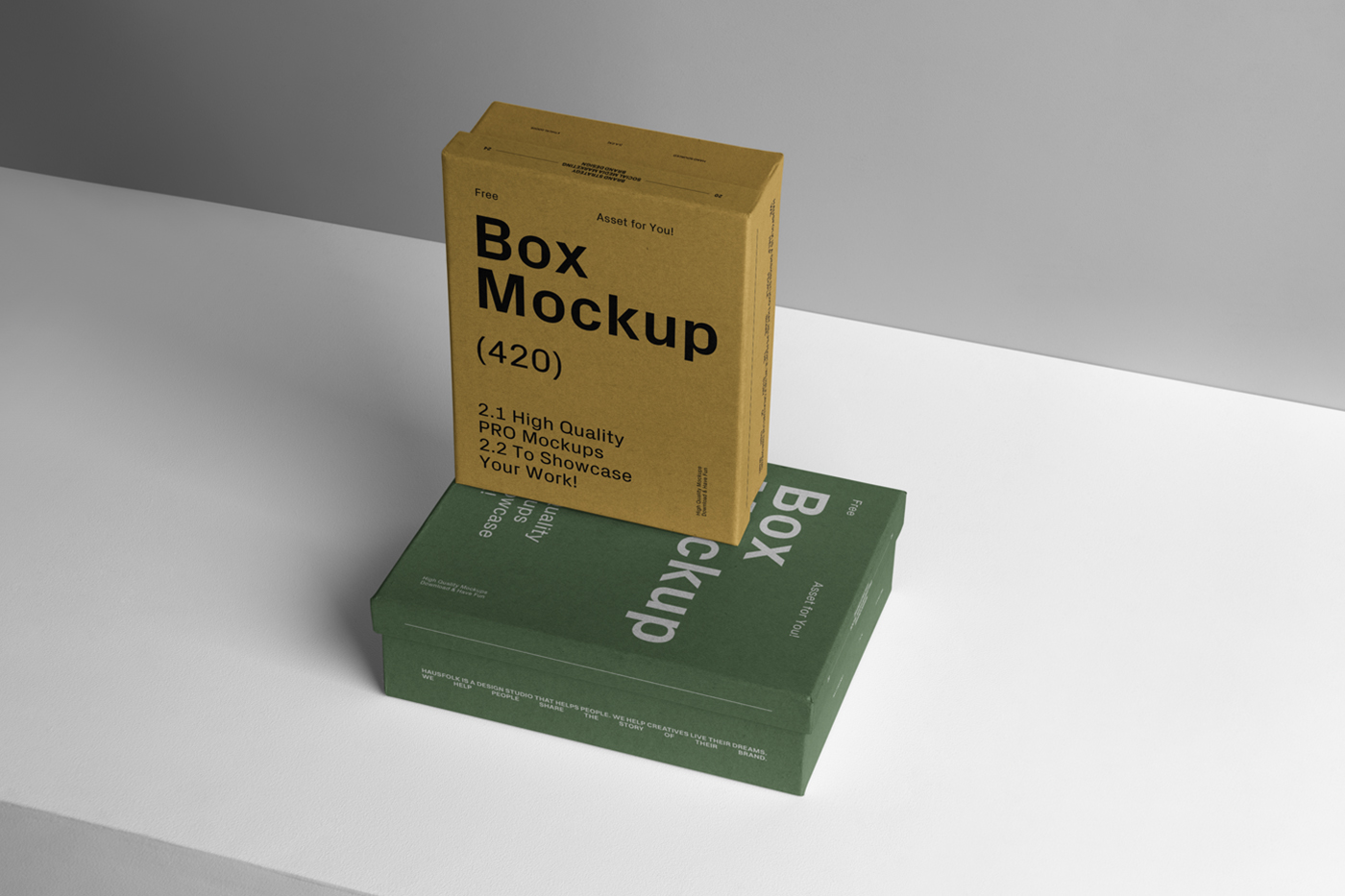 View of two box mockups with black and white typography design lying on top of each other on the white table and visible gray color wall in the background.