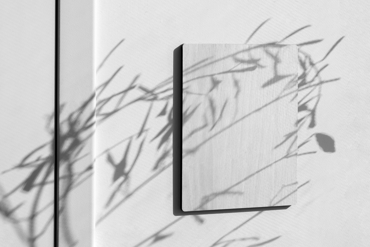 Rectangle white Wood Sign Mockup attached to the white wall.