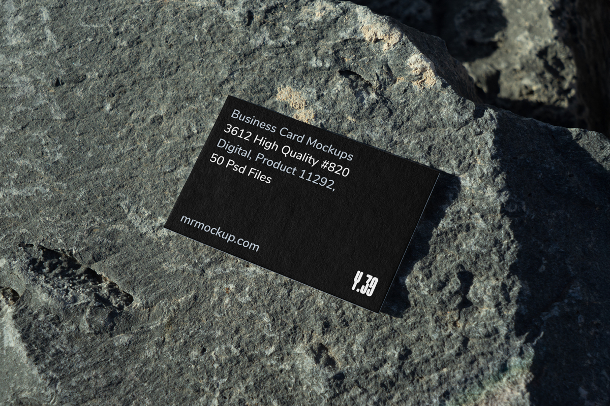 View from above, single outdoor business card mockup with blue and black colors, strong typography design, laying on massive stone.