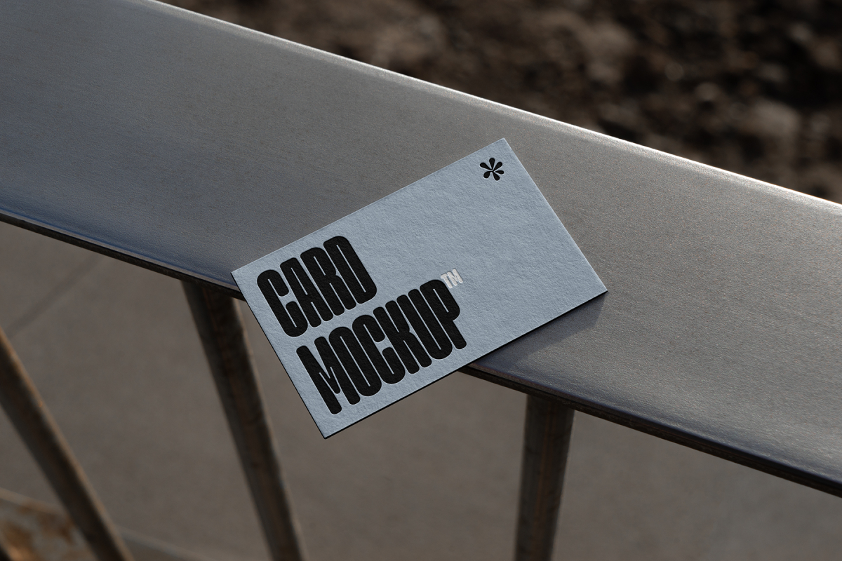 View from above, single outdoor business card mockup with blue and black colors, strong typography design, laying on the balcony railing.