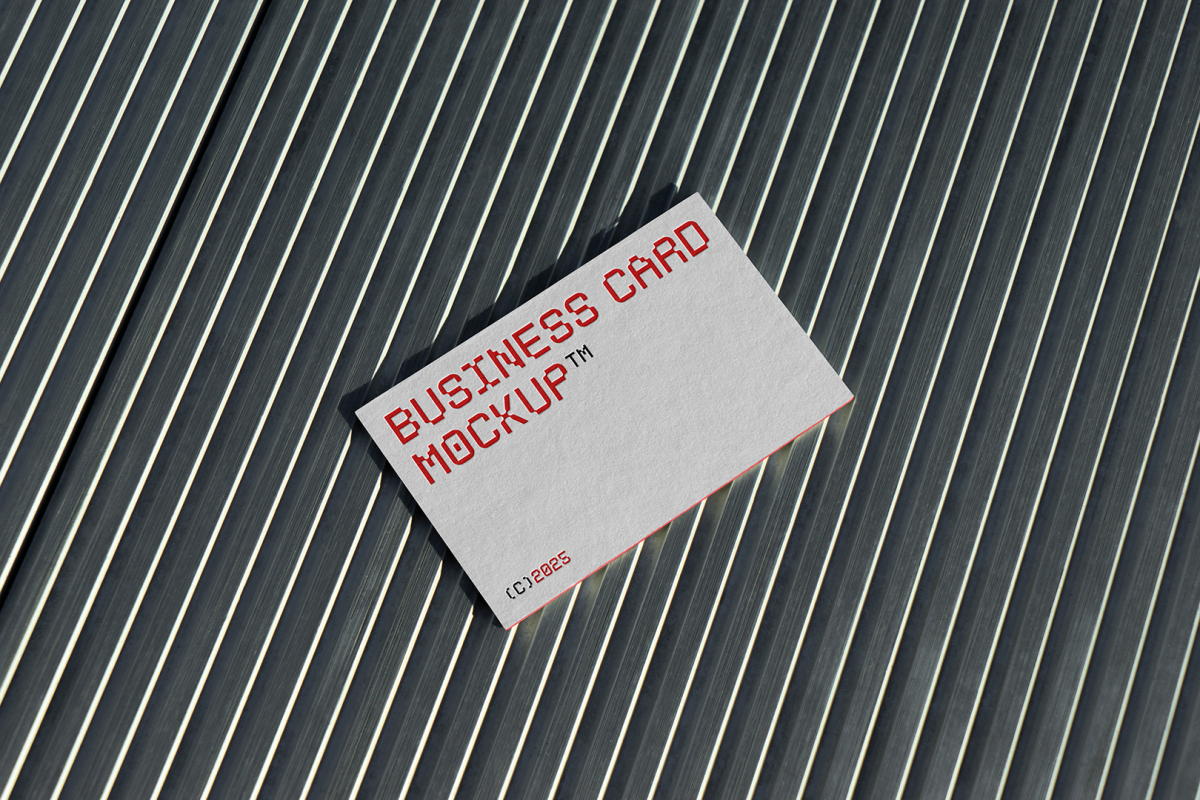 View from above, single outdoor business card mockup with red and white colors, geometric typography design, laying on roof tiles.