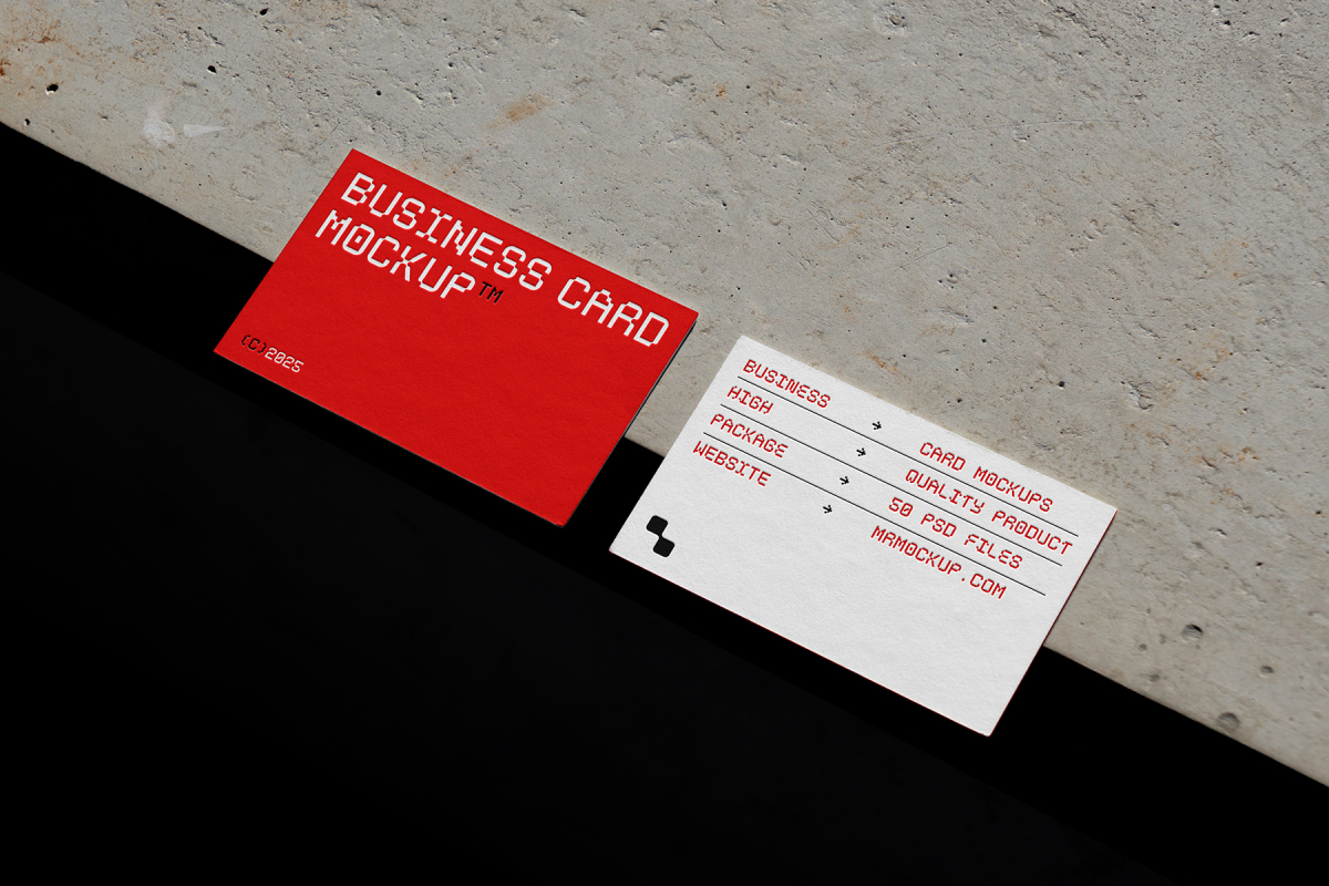 View from above, two outdoor business card mockups with red and white colors, geometric typography design, laying on the concrete.