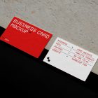 View from above, two outdoor business card mockups with red and white colors, geometric typography design, laying on the concrete.