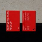 View from above, two outdoor business card mockups with red and white colors, geometric typography design, laying on the concrete.